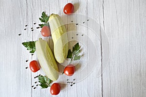 zucchini, tomatoes, parsley on a wooden background with copyspace