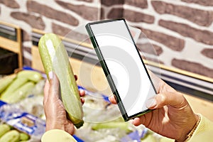 Zucchini vegetable in store and smartphone