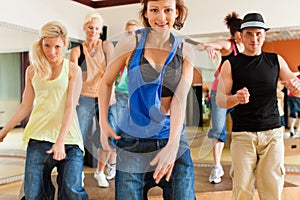 Zumba or Jazzdance - people dancing in studio