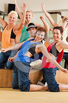 Zumba or Jazzdance - young people dancing in studio