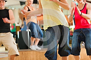 Zumba or Jazzdance - young people dancing in studio