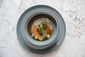 Zuppa di pesce - Italian fish soup in gray plate photo