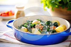 zuppa toscana with potato chunks, bright daylight