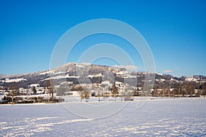 Zurcher Oberland Bachtel mountain view from Tann, Ruti, Bubikon at sunny day with snow covered landscape