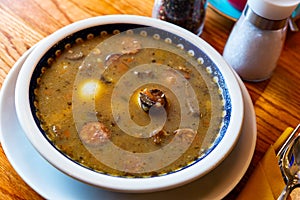 Zurek staropolski - old Polish style sour rye soup served with sausage and egg