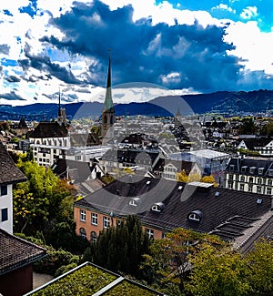 Zurich chruch tower old town historic city centre valley view from zurich university switzerland sun shadow mountain