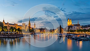 Zurich downtown skyline with Fraumunster and Grossmunster churches at lake zurich at night, Switzerland