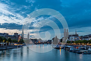 Zurich downtown skyline with Fraumunster and Grossmunster churches at lake zurich at night, Switzerland