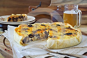 Zwiebelkuchen with prunes and mug of beer