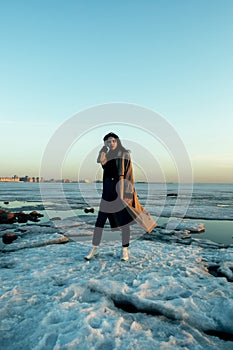 Ãâeautiful girl in raincoat winter Gulf of Finland. photo