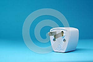 Ã Â¸ÂºÃ Â¸ÂºÃ Â¸Â´Broken Adapter plug on blue background - Power electrical converter Concept - Object isolated