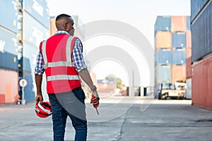 à¹‡Hand Foreman holding walkie- talkie for control working at Container cargo site. Handheld walkie talkie for outdoor