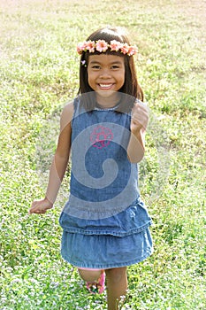 à¹‹Happy girl running in flower field.