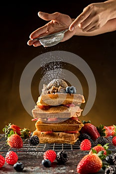 à¹‡How to powdering traditional homemade waffles with icing sugar. Waffles with ice cream, caramel sauce and fresh berries.