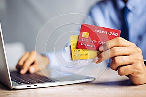 à¹‰Online payment hands holding credit card and using laptop. Online shopping concept