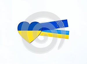 â€‹â€‹Heart with national flag colours of Ukraine and fabric ribbons with flag of Ukraine and European Union on white background.
