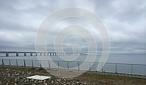 The Ã–resund bridge seen from MalmÃ¶ Sweden on a foggy gray summer morning