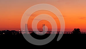 The Ã–resund bridge sunset silhouette during warm summer evening