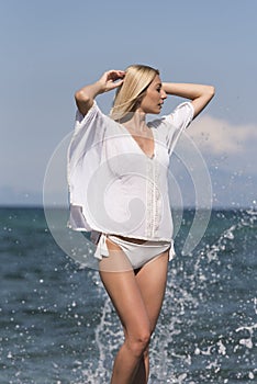 Î’londe woman wear white bottom bikini and long shirt