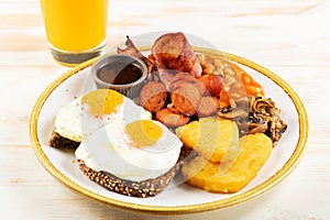 Î’reakfast plate with fried eggs, sausages, nuggets and juice. Healthy food concept