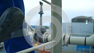 Ð•ngineer feet climbing the tower of a large oil refinery. Close-up