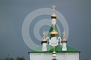 Ð—Ð¾Golden Church domes against the dark stormy sky