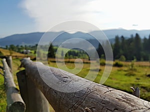 Ð¡lose-up. Log. Beautiful mountains landscape. Ð¡ountryside meadow. Peacefulness. Carpathian