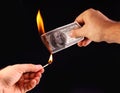 $ 100 in hand, set fire to a match. Royalty Free Stock Photo