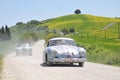 A 1955 Porsche and a 1955 green Lancia Aurelia
