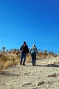 2 adults walking up a path