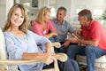 2 Mid age couples socialising at home Royalty Free Stock Photo