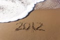 2012 written in sand with waves Royalty Free Stock Photo