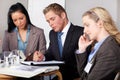 3 business people working on some calculations Royalty Free Stock Photo