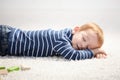 3 year old falling asleep on floor at home Royalty Free Stock Photo