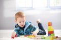 3 year old playing with cubes on floor Royalty Free Stock Photo