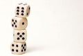 4 dice piled up in front of white background