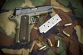 45 Firearm Pistol Clip And Hand Gun on Camouflage Royalty Free Stock Photo