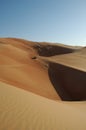 Off-road 4x4 vehicles in the desert dunes under a blue sky with copy space Royalty Free Stock Photo