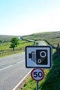 50mph speed camera sign with fast moorland road in Royalty Free Stock Photo