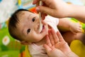 6 month old Asian baby girl being fed cereal Royalty Free Stock Photo