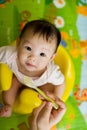 6 month old Asian baby girl being fed cereal Royalty Free Stock Photo