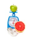 Aa apple, a grapefruit, measure tape and scale Royalty Free Stock Photo