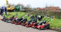 A row of red lawn mowers