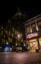 nobis Printen\'s branch on MÃÂ¼nsterplatz in Aachen at Night Royalty Free Stock Photo