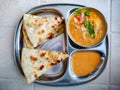 Aalu Paratha, a flat unleavened bread resembling a small nan bread that is fried on a griddle, served with egg curry Royalty Free Stock Photo