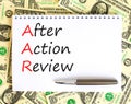 AAR After action review symbol. Concept words AAR After action review on beautiful white note. Dollar bills. Beautiful dollar