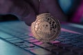 Aave crypto coin placed on reflective surface in dark background