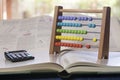 Abacus and calculator on a books Royalty Free Stock Photo