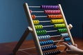 Abacus with colorful beads on blue background, close up, Counts kids learning, with counting child\'s hands Royalty Free Stock Photo