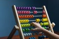 Abacus with colorful beads on blue background, Counts kids learning, with counting child\'s hands Royalty Free Stock Photo